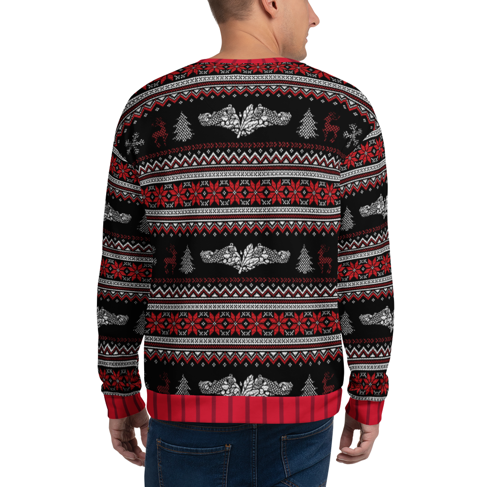 Person wearing a festive sweater with red, black, and white pattern on a white background