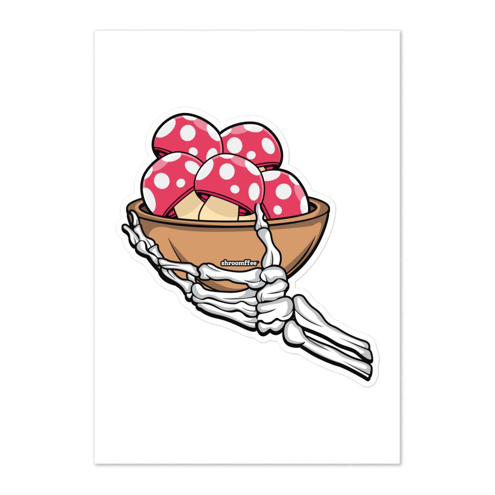 Skeleton hand holding a bowl with red polka dot mushrooms on a white background