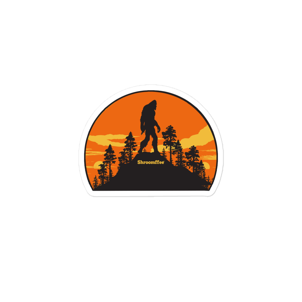 Sticker with a silhouette of a bigfoot in a forest at sunset, featuring the brand 'Shroomfee'.