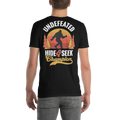 Black t-shirt with 'Undefeated Hide & Seek Champion' design featuring a silhouette of a person and trees on a white background.