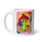 Mug with colorful design featuring mushrooms and flowers on a white background