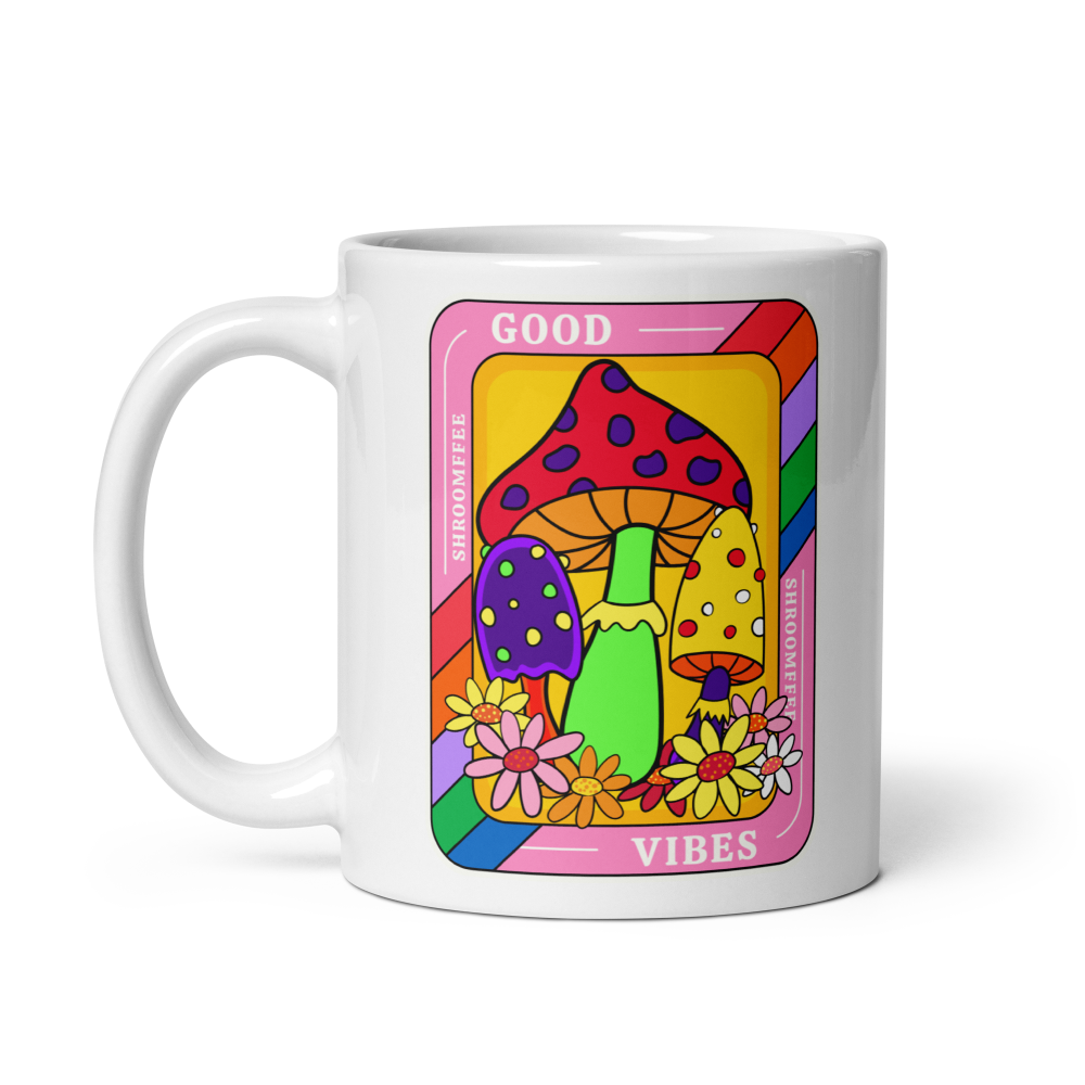 Mug with colorful design featuring mushrooms and flowers on a white background