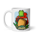 White mug with a cartoon frog on a mushroom design, brand 'shroomffee visible