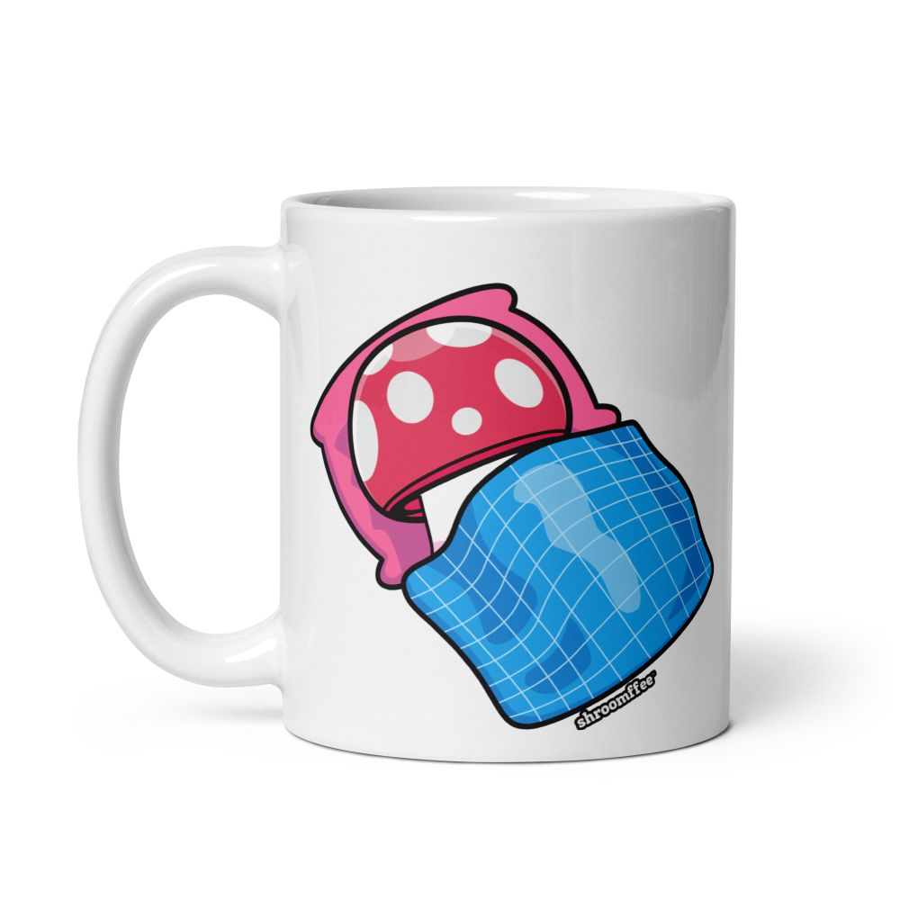 White mug with pink and blue mushroom design on a white background