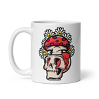 White mug with a skull design wearing a red bandana and flowers on a white background