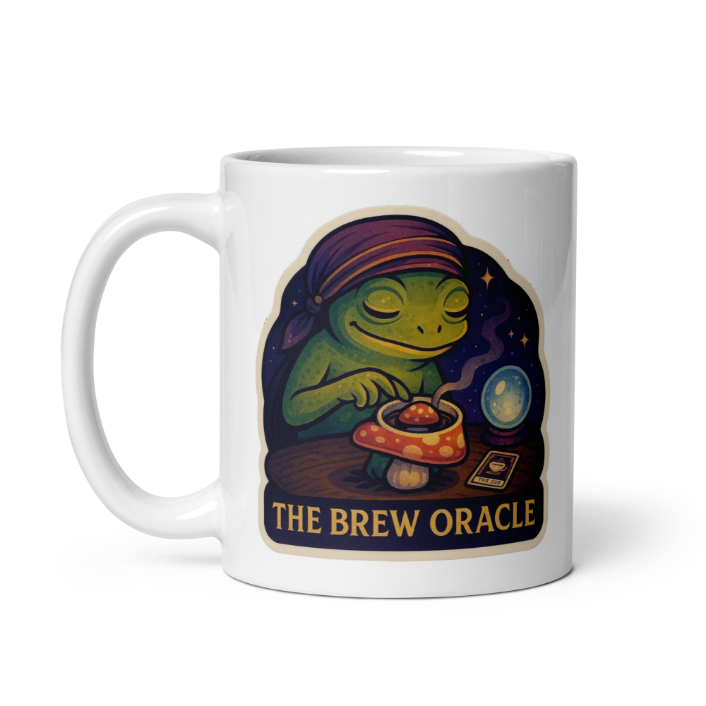 White mug with a colorful design of a frog and text 'The Brew Oracle' on a white background
