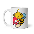 White mug with a cartoon bee holding a mushroom design on a white background