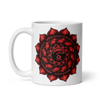 White mug with a red mandala design on a white background
