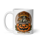 White mug with a design of a pumpkin and mushrooms on a white background