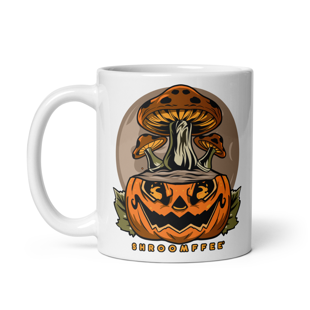 White mug with a design of a pumpkin and mushrooms on a white background