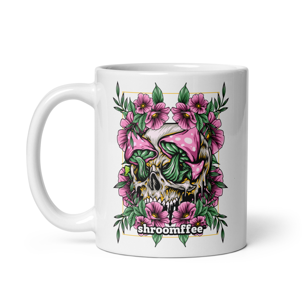 Mug with skull and mushroom design featuring pink flowers on a white background