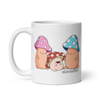 White mug with cartoon characters wearing mushroom hats on a white background