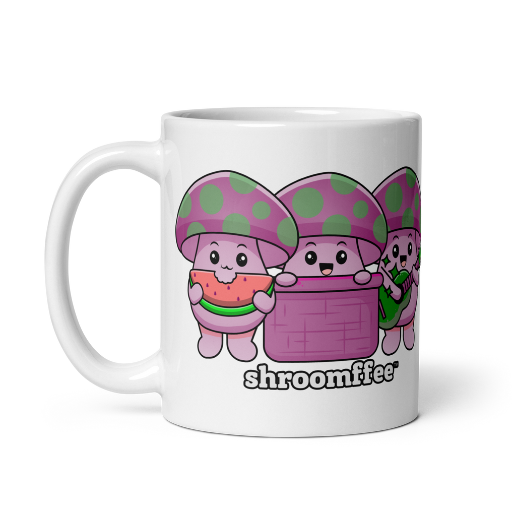 A white ceramic mug with cartoonish mushroom characters in pink and purple colors, with the word 'shroomies' written on it.