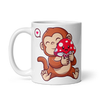 White mug with a cartoon monkey holding a red mushroom with white spots design on a white background