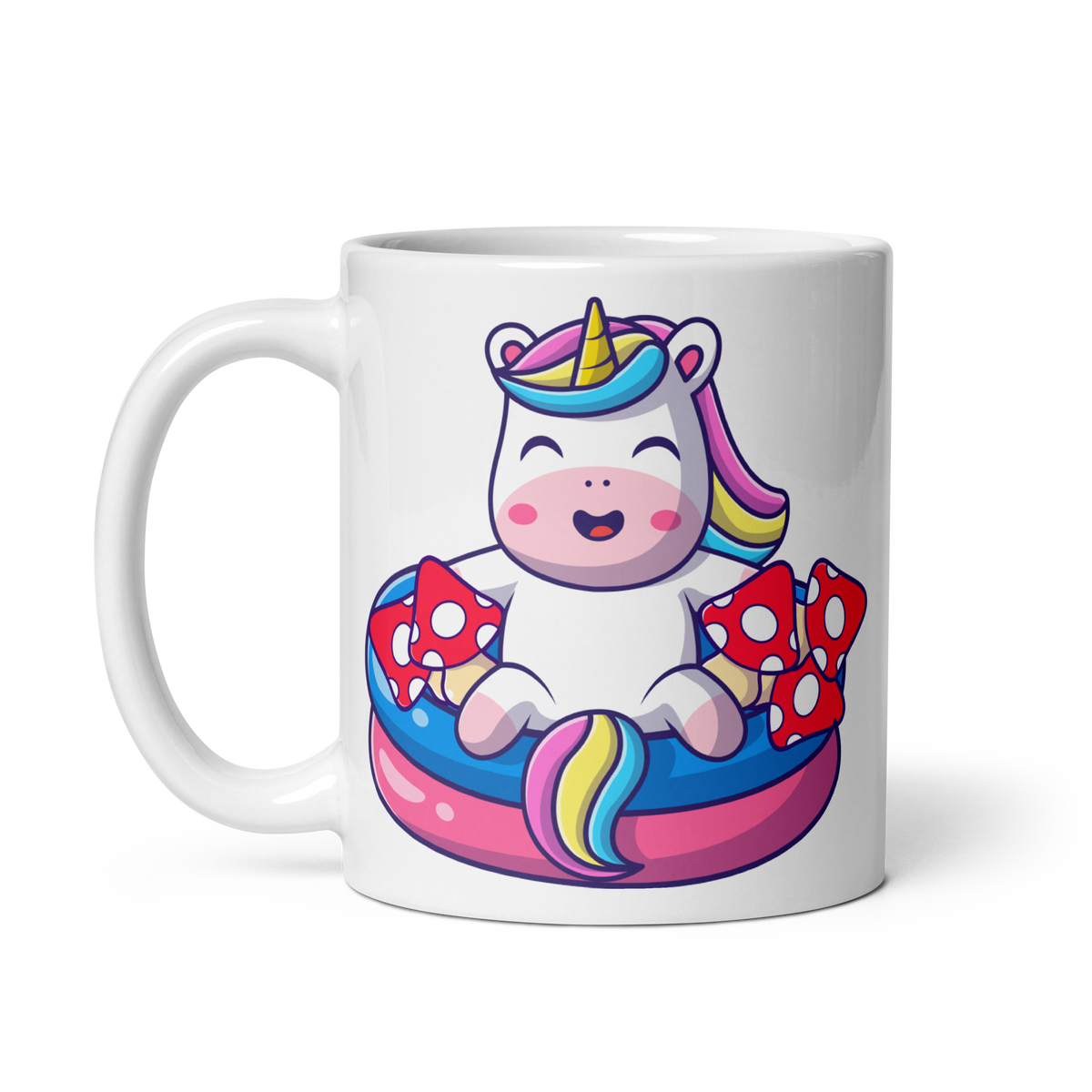A white ceramic mug with a colorful illustration of a unicorn sitting in a pool filled with mushrooms.
