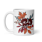 White mug with mushroom and leaf design on a white background