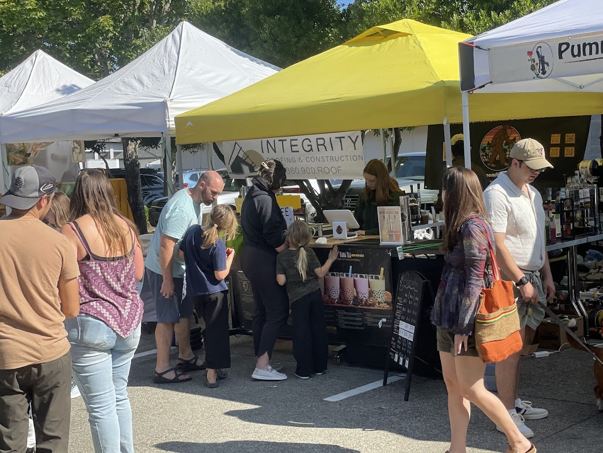 Customers gathering around our beverage booth at the Poulsbo Farmers Market